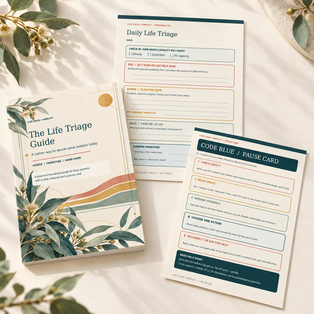 A set of mental health first-aid guide cards and a notebook titled 'The Life Triage Guide' arranged on a light fabric background with decorative leaves. The items include a notebook cover, a daily life triage sheet, and a code blue / pause card.